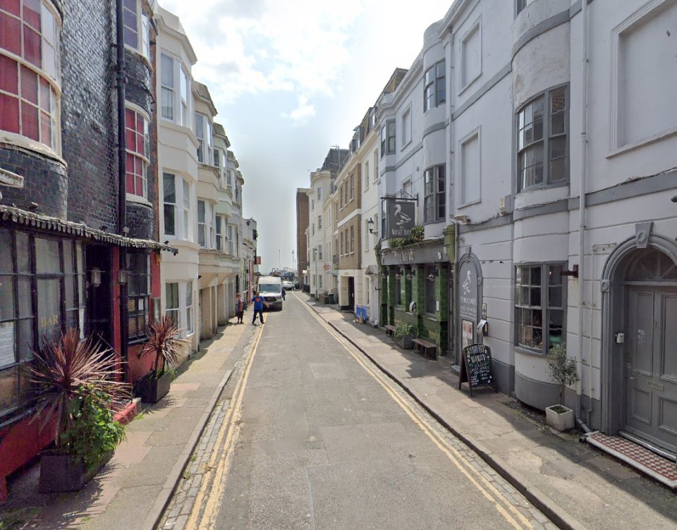 Street view of Manchester St in Brighton, showing buildings and a pub.