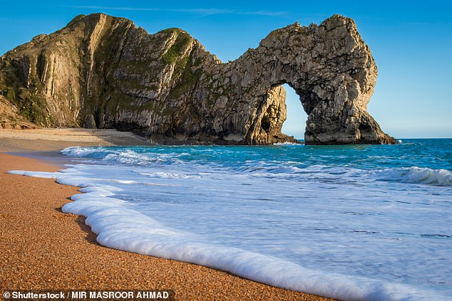 A woman in her 30s has died at the popular Durdle Door beach (pictured) during the hottest day of the year