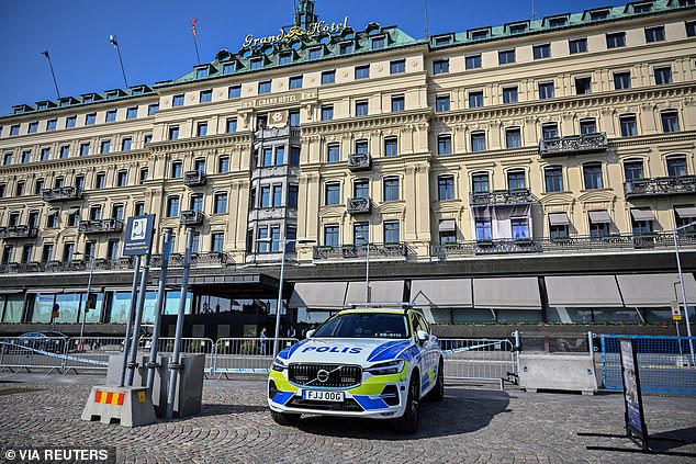 A Swedish police vehicle is parked outside the Grand Hotel during the Bilderberg meeting in Stockholm