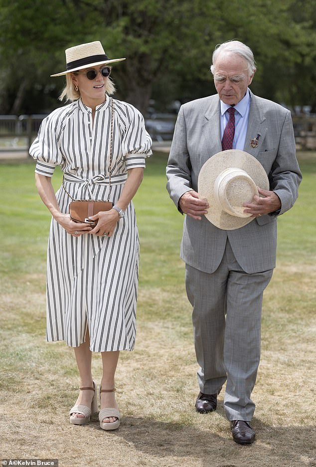 Wearing a fashionable navy striped summer dress, belted at the waist, Zara Phillips, 44, looked elegant as she prepared to present the Royal Windsor Cup on Sunday