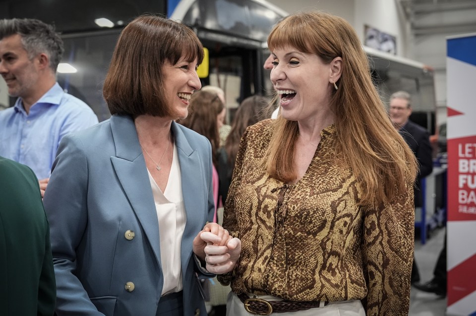 Rachel Reeves and Angela Rayner smiling and holding hands.