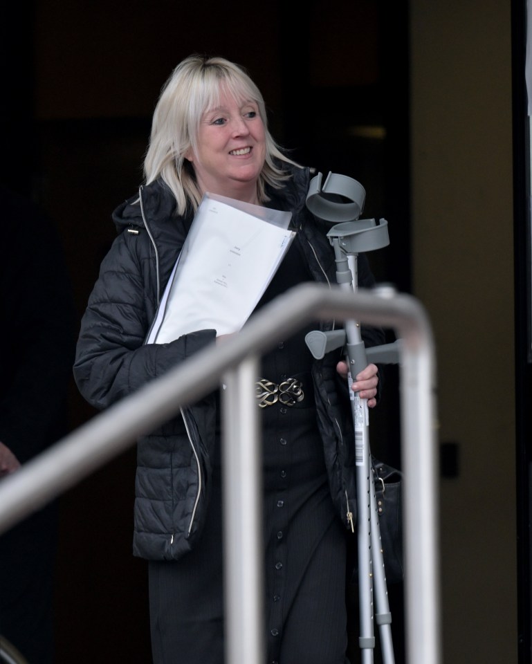 Katherine Hill, using crutches, leaves court.
