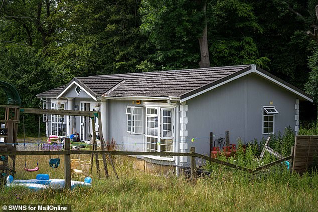 The chalet home, off a private lane, has plush grey furniture and is adorned with family pictures