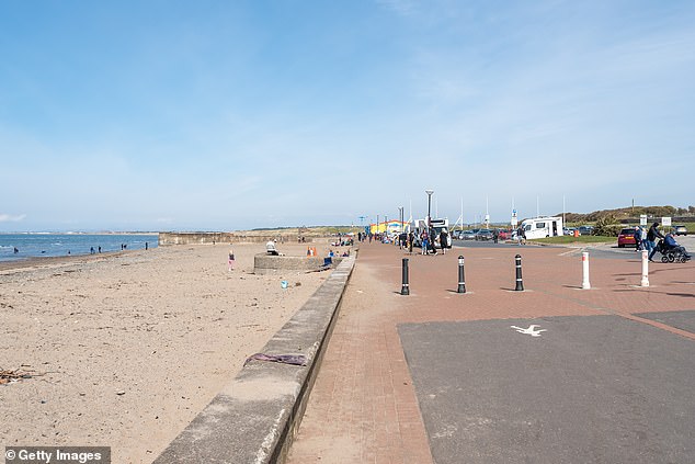 A witness reported encountering the leg bone 'buried under some seaweed' with 'the sock and shoe till on it'. Pictured: Beach and shore area of Prestwick (file image)
