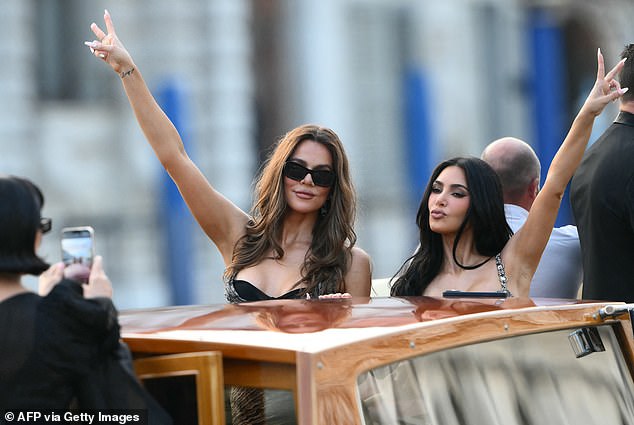 The star pictured during the Bezos wedding festivities with her sister Kim; pictured June 26