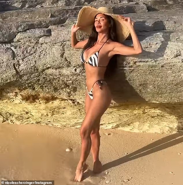The beauty showcased her toned figure wearing a black and white-striped bikini top as well as matching bottoms
