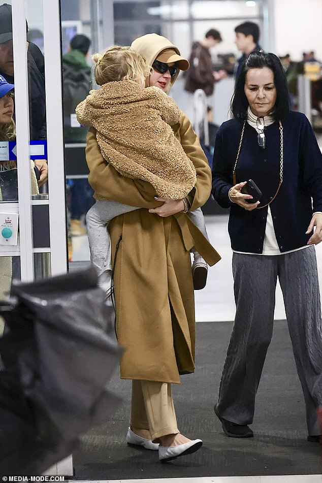 The singer was dressed for Sydney's incredibly chilly winter weather in a camel-toned coat paired with a cap in a similar beige tone