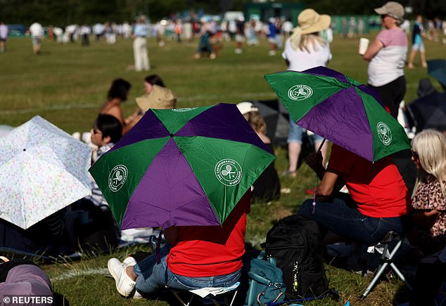 Some tennis fans in the queue took to using umbrellas to shield themselves from the sun