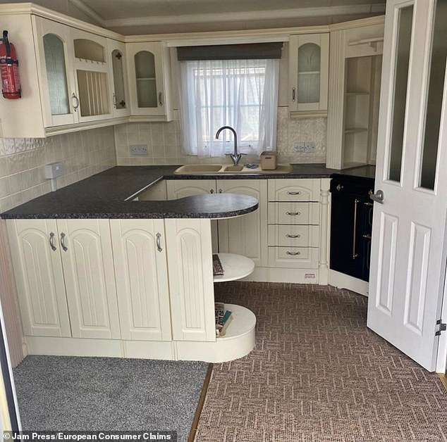 The house kitchen before John's improvements, which site bosses say have devalued the caravan