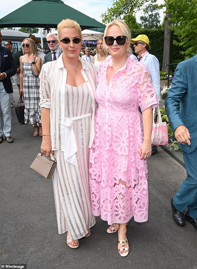 The actress was all smiles as she she struck a pose with wife Ramona Agruma, who was chic in a white striped co-ord