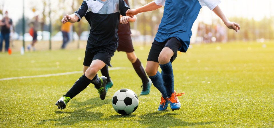 Two young soccer players vying for the ball.