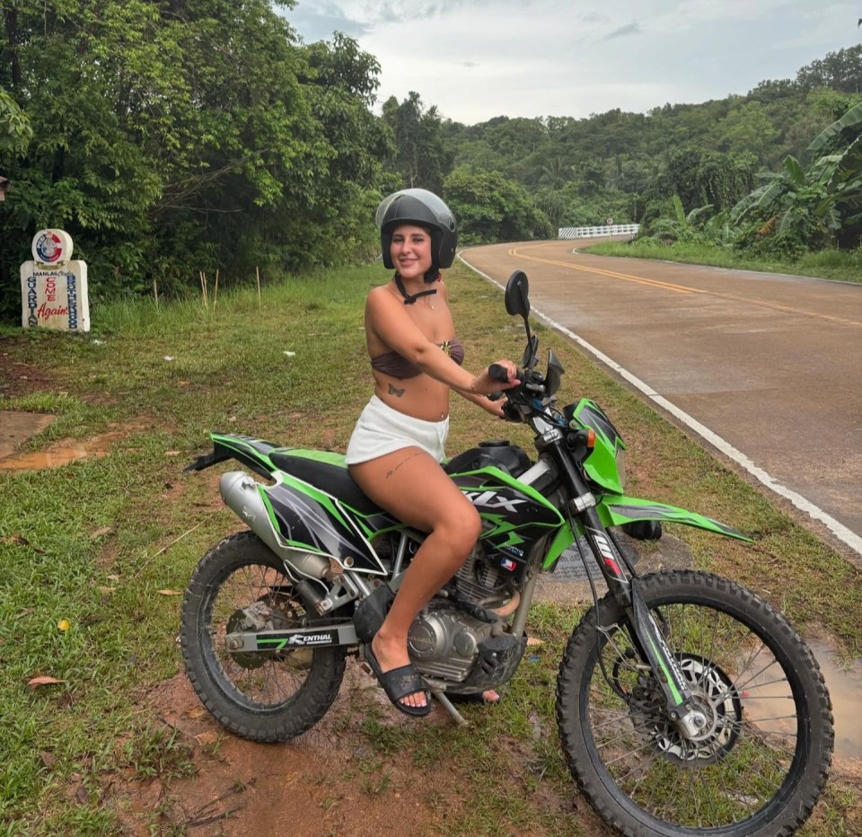 Woman on a green dirt bike.