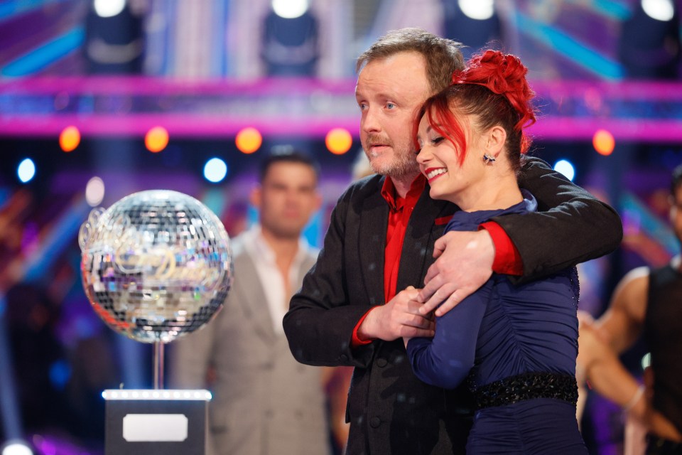 Chris McCausland and Dianne Buswell holding the glitterball trophy after winning Strictly Come Dancing.