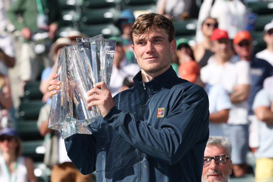 Jack Draper holding a tennis trophy.