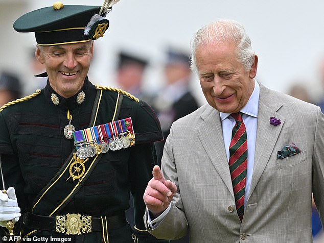 Britain's King Charles III talks with a Member of Royal Company of Archers during the traditional Ceremony of the Keys in the Gardens of the Palace of Holyroodhouse in Edinburgh, Scotland on July 1