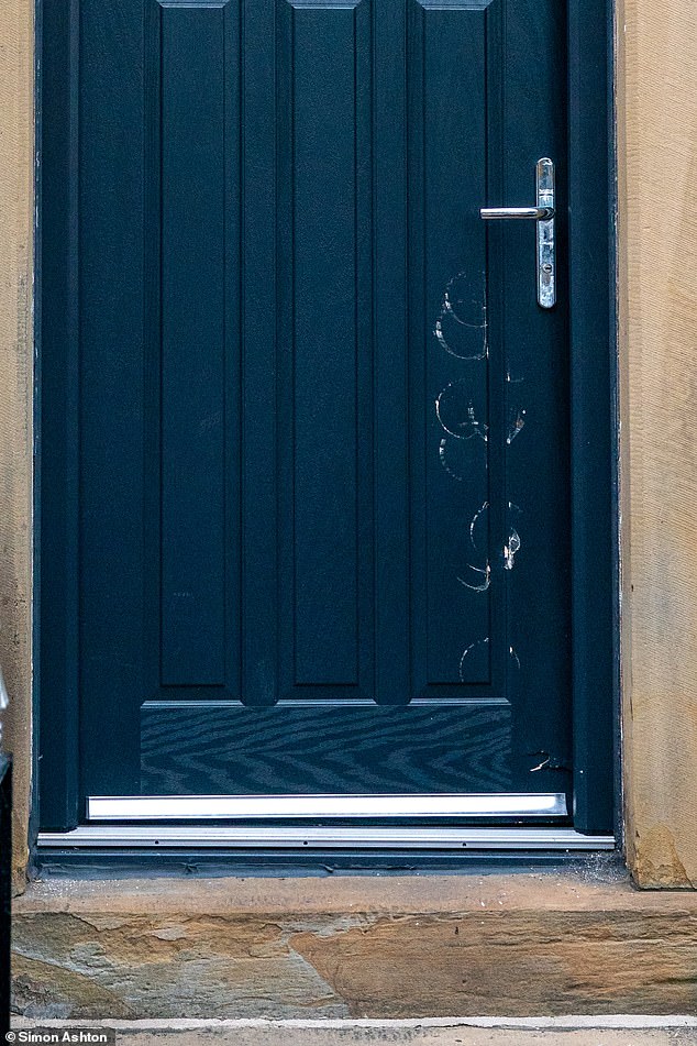 The uniformed men, both West Yorkshire Police and Home Office Immigration officers, then made their way into the house. Pictured: The damage done to the door by The Enforcer