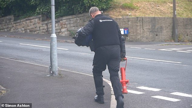At 6am the team was given the Go order and the police vans sped through the still deserted streets of Batley. Pictured: The Enforcer being carried to the house