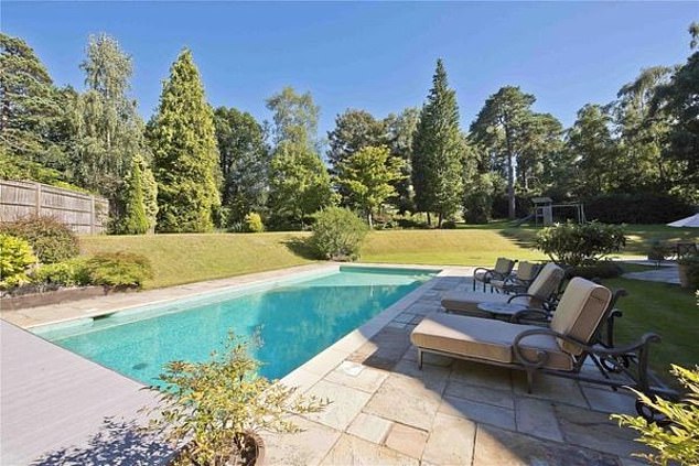 After no buyers came forward after eight months Sir Mo is now hoping to get the sale back on track by dropping the price. Pictured: the stunning outdoor pool which is surrounded by trees