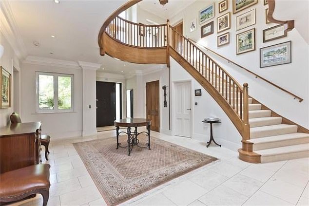 The ground floor of the property, which is 'finished to excellent standards' with modern fittings, has an 'impressive' reception hall (pictured)