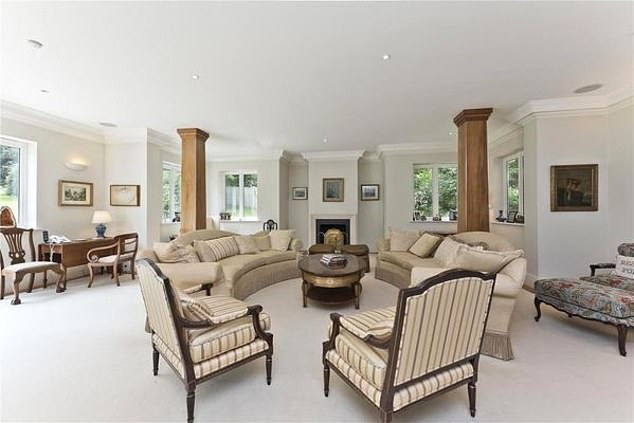The house has an acre of land which includes 'beautifully landscaped gardens' as well as a wooded area with a stream and a bridge
