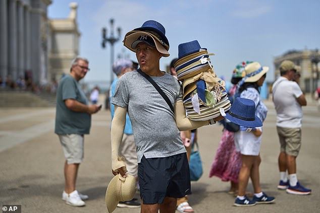 Pictured: A vendor sells hats during a heat wave in Madrid, Spain, July 1, 2025