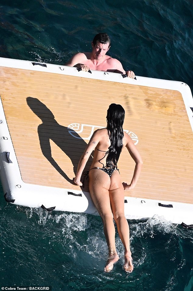 Her long raven tresses were wet after plunging into the crystal-clear water to cool off