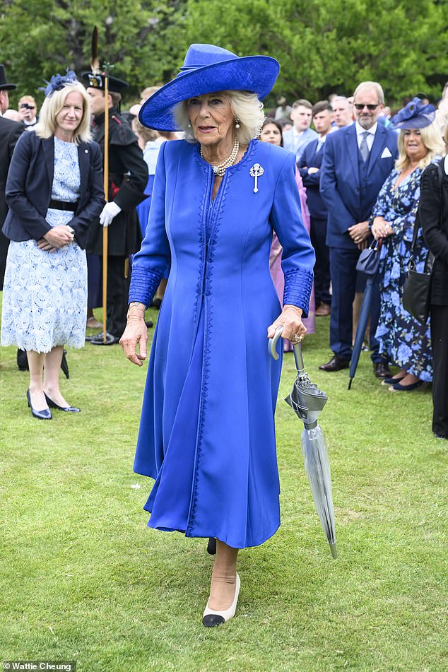 Queen Camilla put on a striking display in a royal blue Fiona Clare dress and coat with a matching Philip Treacy hat