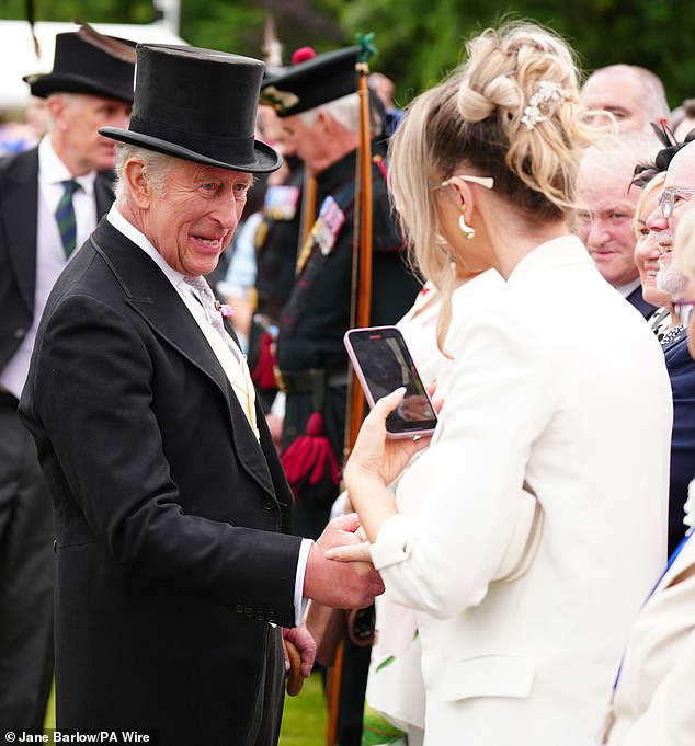 The 76-year-old appeared cheerful as he shook hands with an attendee during the garden party today