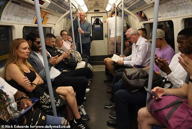 A very hot morning on the London Underground yesterday as passengers travel on the Jubilee line
