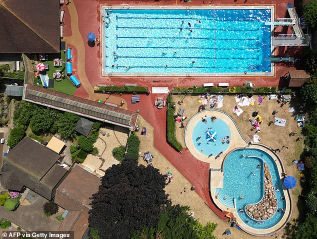 Swimmers enjoy the water at the Faversham Pools complex in Kent yesterday morning