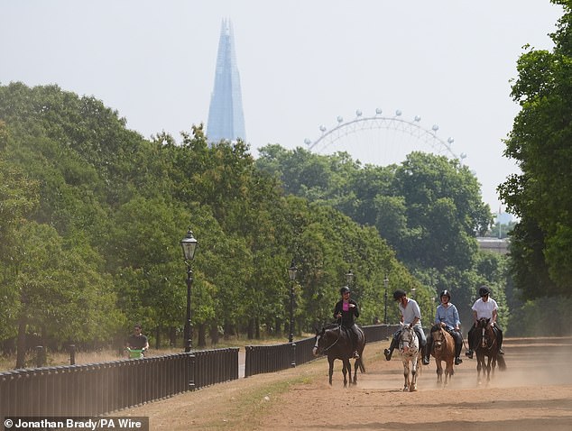 People on horseback in the dry conditions in Hyde Park in London yesterday morning