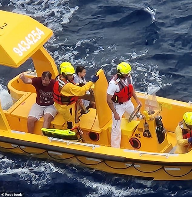 The dad, clearly exhausted and distraught, gave the crowd a thumbs up as the boat approached the ship