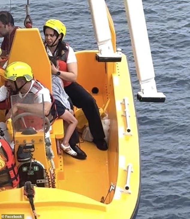 The ship's doctor has been praised online for stroking the girl's hair to keep her calm