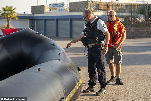 Tories predicted that this year's annual total could hit a record-breaking 50,000. Pictured: Police piercing a small boat with a knife today