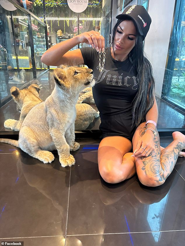 Ms Davies, who owns two French bulldogs, admitted the mauling had left her worried to be around other animals (she is pictured with a lion cub)