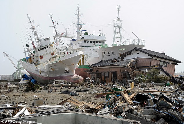 In 2011, a magnitude nine earthquake struck about 81 miles off the coast beneath the North Pacific. The earthquake produced waves up to 132ft tall in some places and killed 15,500 people. Pictured: Fishing boats washed up by the tsunami in Miyagi Prefecture