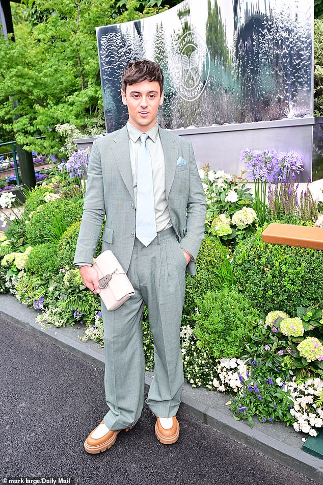 Tom Daly opted for a grey suit with oversized trousers and very chunky orange and white loafers