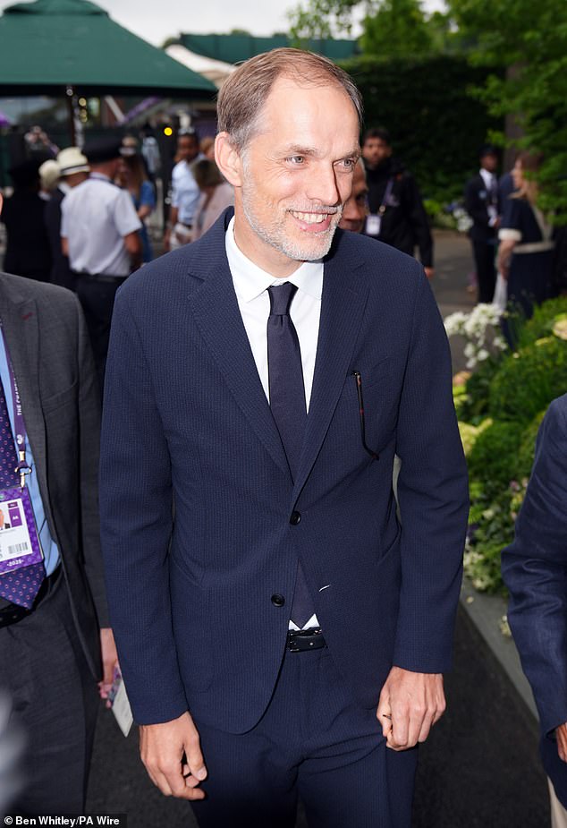 The German professional football manager, 51, beamed in snaps as he opted for a navy suit