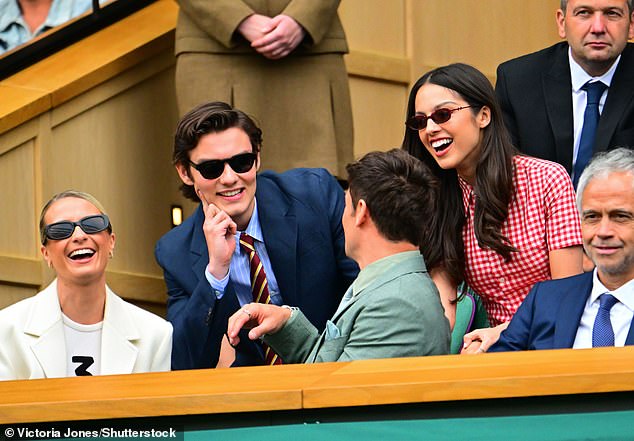 Olivia and boyfriend Louis looked in great spirits on the outing as they enjoyed a chat with Tom