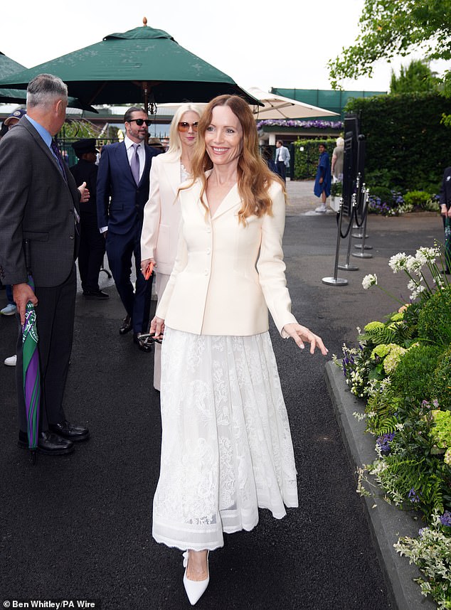 The star completed the look with a white lace skirt and white heels and carried her shades in her hand