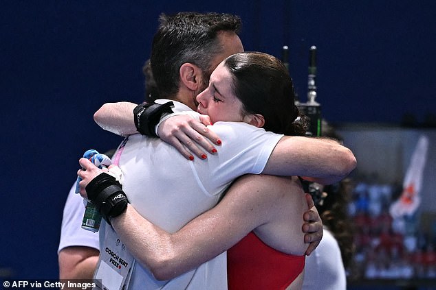The Team GB star, pictured in a tearful embrace with her father, will not compete at this year's World Championships in Singapore