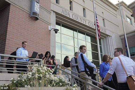 People wait in line to get seats for the Bryan Kohberger plea deal hearing outside the Ada County Courthouse on Wednesday, July 2, 2025, in Boise, Idaho. (AP Photo/Jenny Kane)