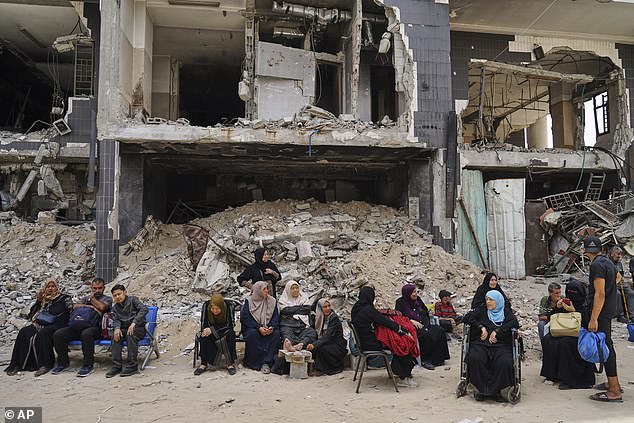 Patients sit outside the destroyed Shifa Hospital compound in Gaza City on Tuesday, July 1
