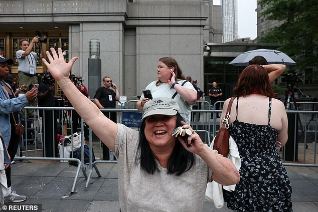 A woman is seen smiling from ear-to-ear outside the courthouse following the shock verdict