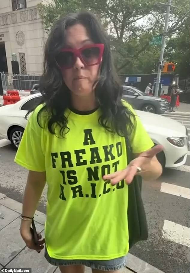 A female supporter wearing 'A FREAKO IS NOT A R.I.C.O' shirt