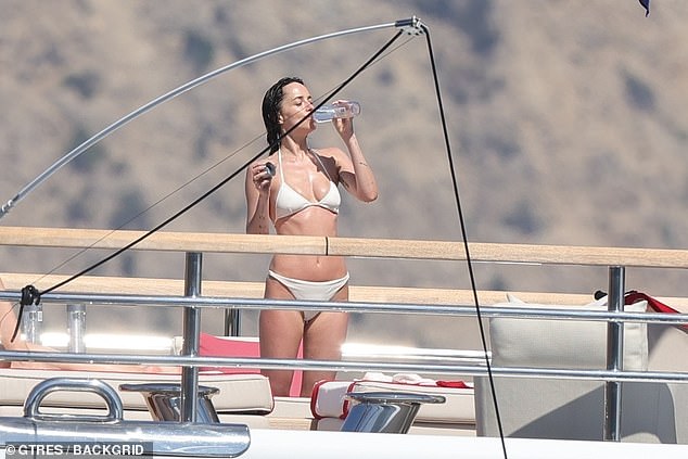 Dakota cooled off with a drink as she soaked up the rays and took in the sights—while serving plenty of her own