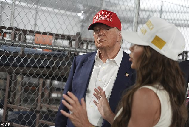 President Donald Trump listens to Homeland Security Secretary Kristi Noem, as they and others tour "Alligator Alcatraz," a new migrant detention facility at Dade-Collier Training and Transition facility, Tuesday, July 1, 2025, in Ochopee, Fla