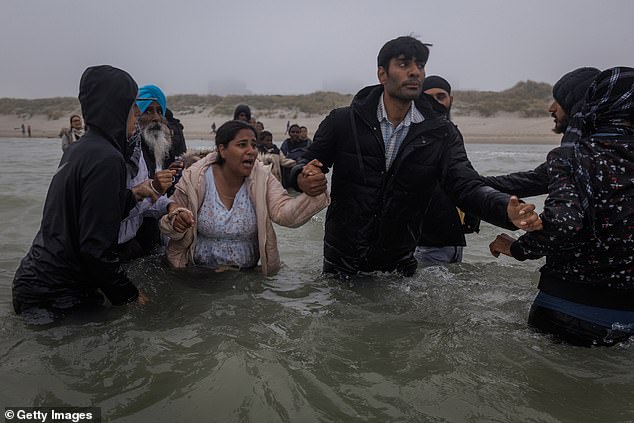 The dinghy promptly motored away from the shore, leaving wailing families who missed their chance to board standing helpless in waist-deep saltwater in heart-rending scenes
