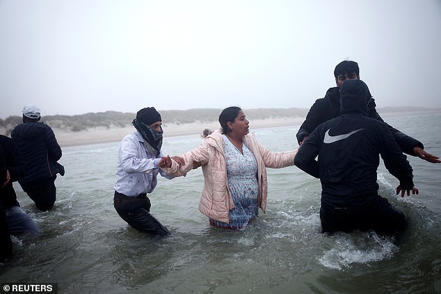 Wearing only socks, the mother with her baby strapped to her back in a life jacket dashed to the boat when it arrived