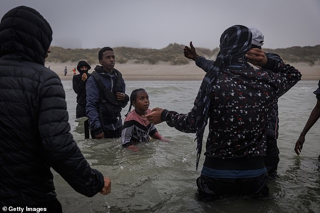 Two children try to make their way past alleged traffickers to a small boat but were unsuccessful in boarding and made their way back to the shore to try another day
